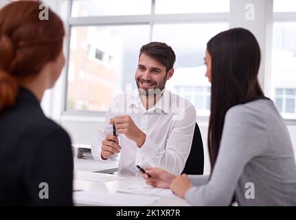 Starting the meeting off on a high note. group of business colleagues having a meeting in an office. Stock Photo