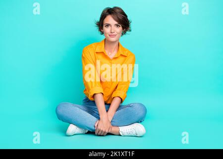 Full size length photo of positive satisfied lady sit good mood free time isolated on cyan color background Stock Photo