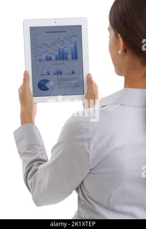 The latest business statistics at her fingertips. Over the shoulder shot of a businesswoman looking at financial data on a digital tablet. Stock Photo