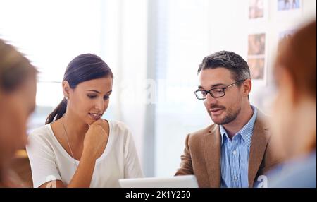 Discussing the details. two colleagues discussing ideas on a tablet. Stock Photo