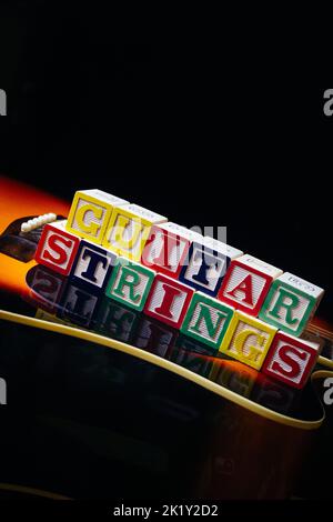 Word or phrase Guitar Strings made with the letter cubes standing