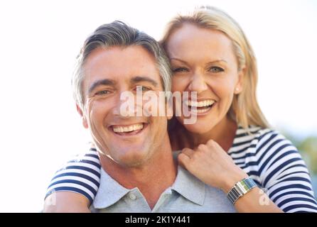 Theyre a couple who knows how to have have fun. Cropped portrait of a handsome mature man piggybacking his wife in the park. Stock Photo