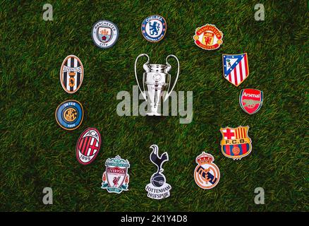 April 21, 2021, Moscow, Russia. UEFA Champions League Cup and emblems of top clubs on the green grass of the stadium. Stock Photo