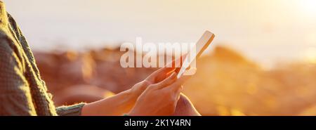 Woman outdoors relaxing with smartphone in her hands. Stock Photo