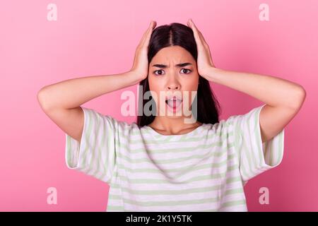 Portrait of confused speechless filipino person hands touch head open mouth isolated on pink color background Stock Photo