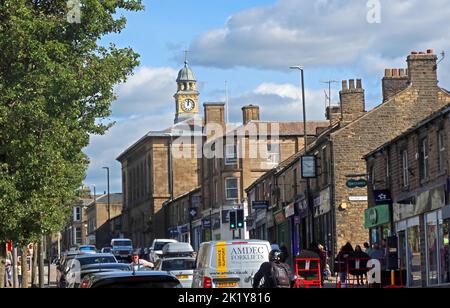 High Street west traffic, in Glossop town centre, leading up to Market Hall and Town Hall clock, High Peak, Derbyshire, England, UK, SK13 8AZ Stock Photo