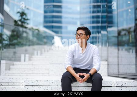 Portrait of a smiling young man in the city Stock Photo
