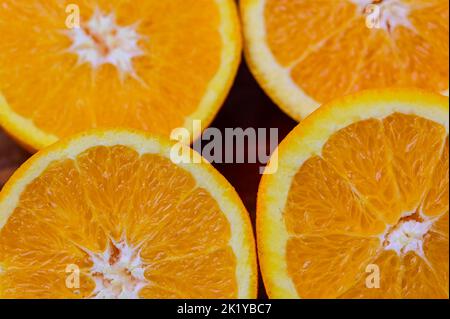 Whole and sliced Oranges on a wood background Stock Photo
