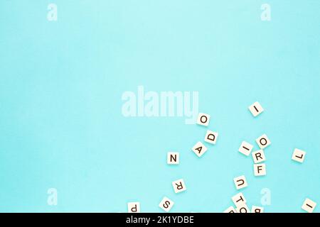 Random letters on a blue background. Scattered English alphabet. Copy space. Abstract minimalist background Stock Photo