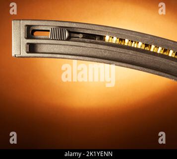 Magazine for a rimfire rifle fully loaded on a beige background and copy space below Stock Photo