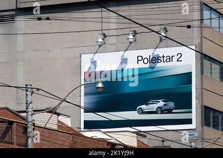 A Polestar 2 advertisement billboard is seen on a building in downtown Toronto; Polestar is a growing electric vehicle manufacturer owned by Volvo. Stock Photo