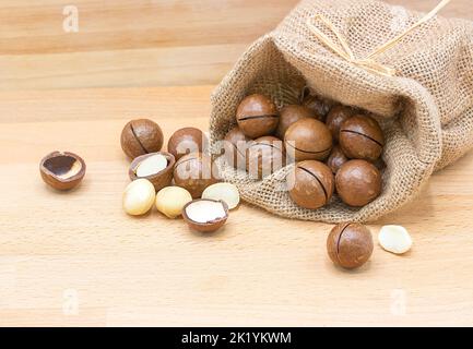 macadamia nuts isolated on a wooden background with copy space Stock Photo