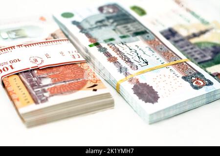 selective focus of stack of new Egyptian money banknotes currency of different values with rubber bands isolated on white background, pile of new poly Stock Photo