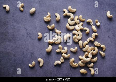 top view of cashew nuts spilling on black background  Stock Photo