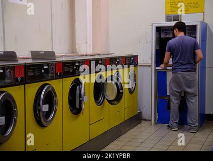 Man using the laundrette in Pimlico London Stock Photo
