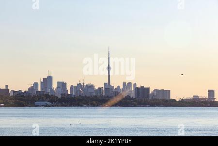 The Toronto skyline with the CN Tower in the centre is seen from across the shore of Lake Ontario in the early morning. Stock Photo