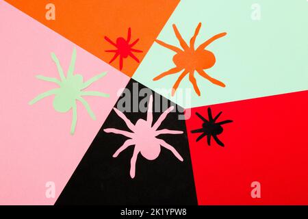 colorful background with colorful paper craft spiders, creative art design, halloween concept, flat lay Stock Photo