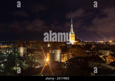 Tallinn, Estonia -  January 4, 2020: night panoramic view of the skyline of Tallinn with medieval towers and walls, and St. Olav's Church in the middl Stock Photo