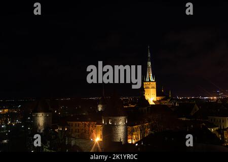 Tallinn, Estonia -  January 4, 2020: night panoramic view of the skyline of Tallinn with medieval towers and walls, and St. Olav's Church in the middl Stock Photo