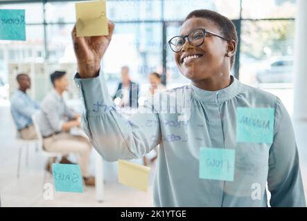Planning, writing and sticky notes with business woman in strategy, marketing or vision meeting in corporate company. Idea, post it, and creative Stock Photo