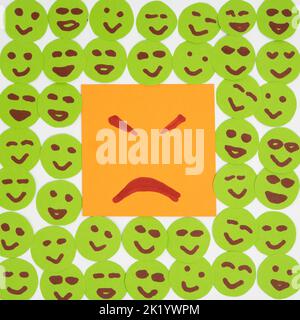 If you are in negative bad mood surround yourself with good positive people - concept with paper faces and sticker Stock Photo