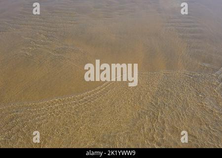 RIPPLES IN THE SAND PHOTOGRAPHED THROUGH THE SEA WATER Stock Photo