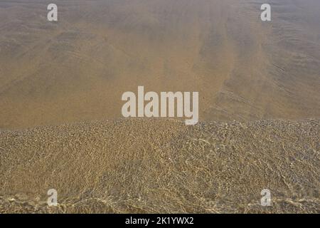 RIPPLES IN THE SAND PHOTOGRAPHED THROUGH THE SEA WATER Stock Photo