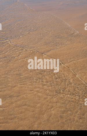 RIPPLES IN THE SAND PHOTOGRAPHED THROUGH THE SEA WATER Stock Photo