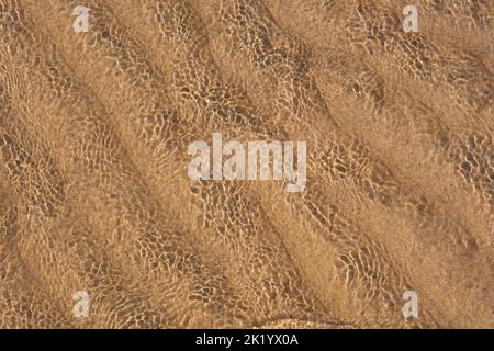 RIPPLES IN THE SAND PHOTOGRAPHED THROUGH THE SEA WATER Stock Photo