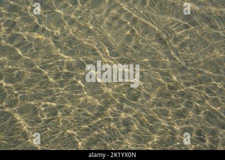 RIPPLES IN THE SAND PHOTOGRAPHED THROUGH THE SEA WATER Stock Photo