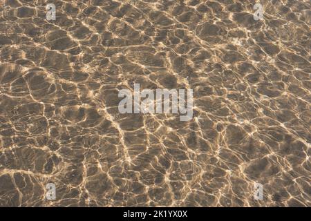 RIPPLES IN THE SAND PHOTOGRAPHED THROUGH THE SEA WATER Stock Photo