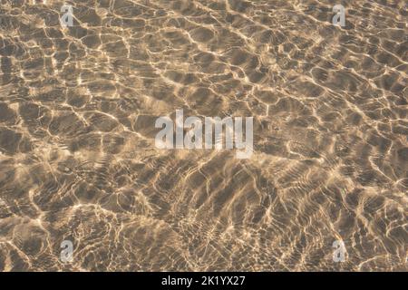 RIPPLES IN THE SAND PHOTOGRAPHED THROUGH THE SEA WATER Stock Photo