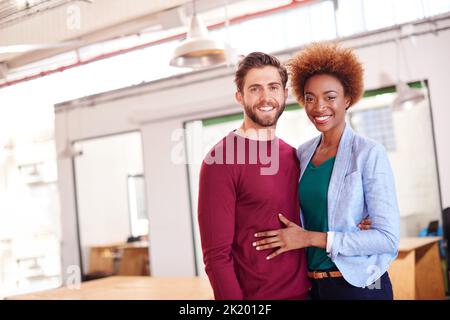 Behind every successful man is a successful woman. a businesspeople at work in an office. Stock Photo