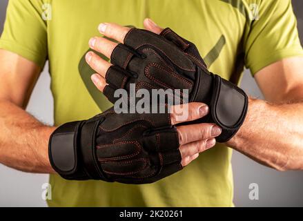 Sport workout gloves closeup on male hands for gym training. High quality photo Stock Photo