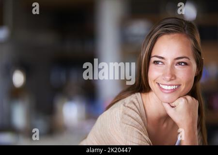 What should I plan for myself today. an attractive young woman relaxing at home. Stock Photo