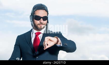 businessman in suit and pilot hat check time Stock Photo