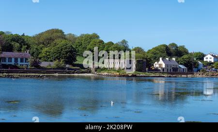 West Cork, Ireland, May 28, 2022. View of ancient ruins and village houses from Clonakilty Bay on a sunny spring day. A small European town, landscape Stock Photo