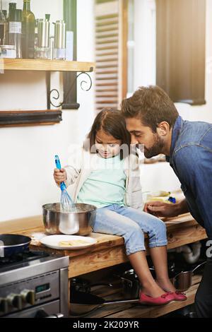 Culinary cuteness. a father and daughter making pancakes together. Stock Photo