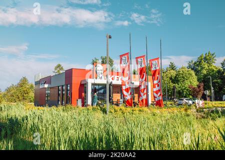 Krakow, Poland - September 11 2022: Exterior building of fast food restaurant KFC (Kentucky Fried Chicken) KFC drive through restaurant Krakow, Poland Stock Photo