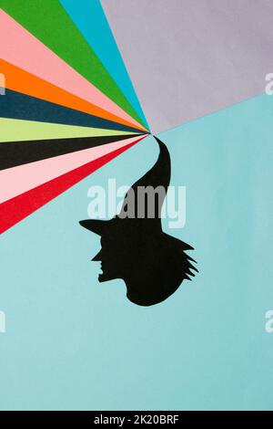 black witch head from hat colorful wave, creative art design, halloween minimal concept, flat lay, paper craft Stock Photo