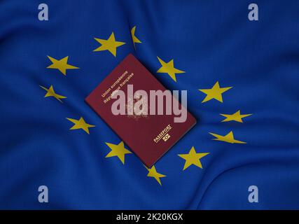France passport with European Union flag in background , French passport is an identity document issued to French citizens Stock Photo
