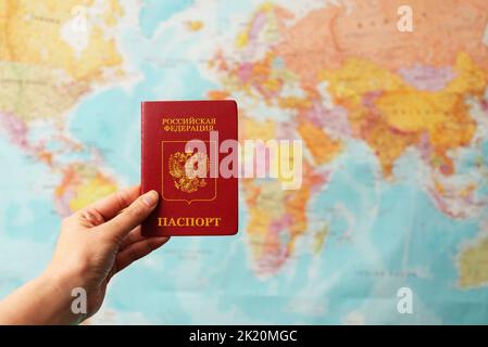 Russian federation passport in front of world map. Stock Photo