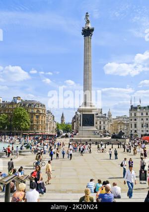 London United Kingdom June 15 2009; Tall corinthian style Nelson's Column in Trafalgar Square with people enjoying summer day in city Stock Photo