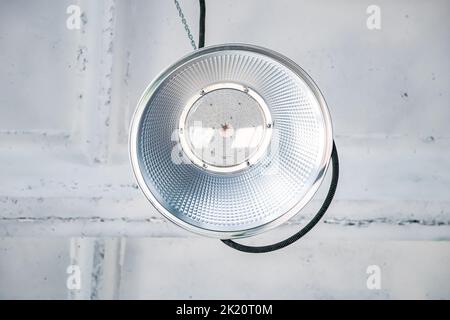 LED lamps on white ceiling in industrial building. Lamps in construction work shop at factory. Stock Photo