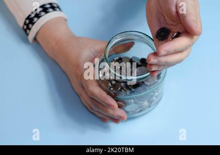 Elderly woman counting coins on table. Close up macro detail of romanian lei banknotes Stock Photo