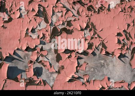 Metal background with cracked paint. The texture of the exfoliating paint of the paint. Background of old painted metal. Peeling paint on metal. Stock Photo