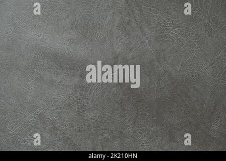 The texture of artificial leather. Background of black leather with patterns. Artificial material made of gray leather. Stock Photo