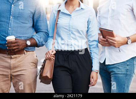 Business people together in the city in the morning on travel to their job. Diversity, support and team of corporate workers in formal fashion clothes Stock Photo