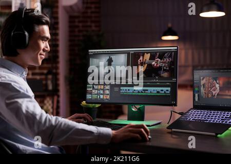 Male videographer editing movie footage with media software, working on film montage production. Creating video content with color grading and visual effects, using computer interface at home. Stock Photo