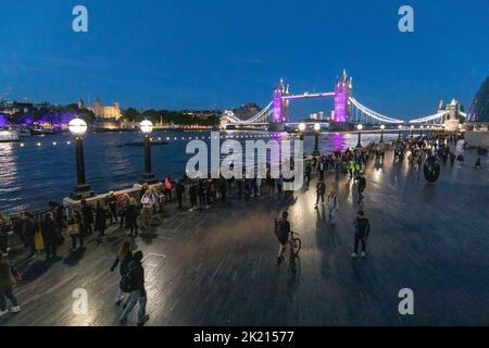Mourners continue to queue in the night along River Thames southbank to see Queen Elizabeth II lie in state in Westminster Hall.   Pictured: Queue in Stock Photo